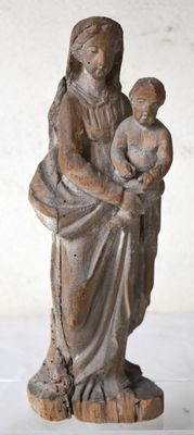 an old statue of a woman holding a child in her arms