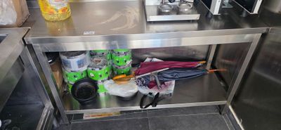 a stainless steel counter with a bunch of items on it