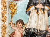an image of a statue of a man holding a cross and a child
