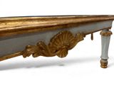 a gold and white table with a mirror on it