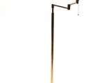 brass floor lamp with a black shade on a white background