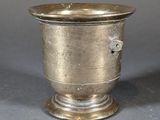 a silver cup that is sitting on a table