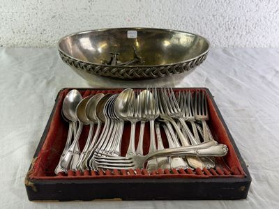 a tray of silverware on a table with a bowl and spoons