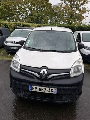 the white van is parked in the parking lot next to other cars