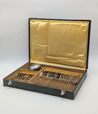 a black case with silverware in it on a white surface