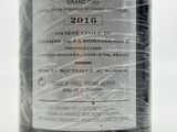 a bottle of wine wrapped in plastic on a table