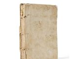 an old book sitting on top of a table next to a white background