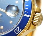 a close up of a watch with a blue face