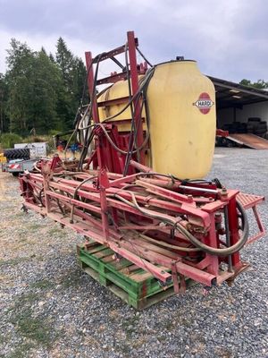 a red tractor with a yellow tank sitting on top of it
