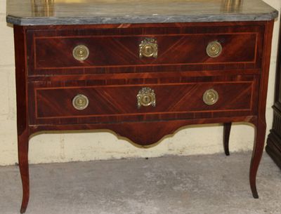 a dresser with a mirror on top of it in a room