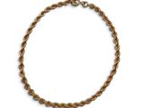 a close up of a gold rope bracelet on a white background
