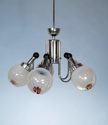 a chandelier with three lights hanging from the ceiling