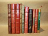 books are lined up in a row on a beige surface