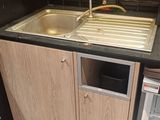 a kitchen with a sink, refrigerator and a dishwasher