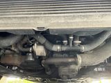 a close up view of a car ' s engine and exhaust pipe