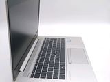 a silver laptop with a black keyboard on a white surface