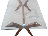 an image of a glass table with wooden legs and a glass top