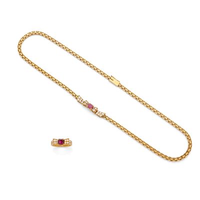 a gold chain with a ruby and diamond clasp