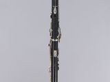 a black and silver clarinet sitting on top of a table