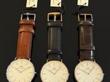 three different styles of watches are displayed on a black surface