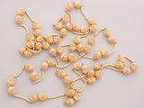 gold plated beaded necklaces and bracelets on a white surface