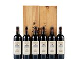 six bottles of wine in front of a wooden box
