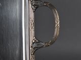 an antique silver plate with a handle on it