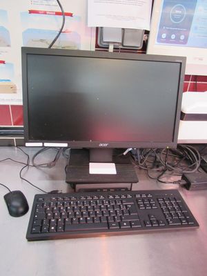 an image of a computer desk with a keyboard and monitor