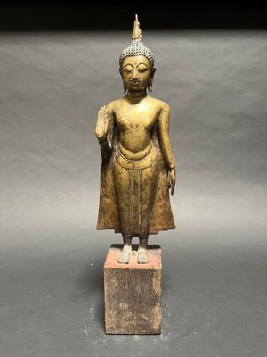 an image of a statue of a person standing on a block
