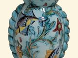 a blue vase that has a fish design on it