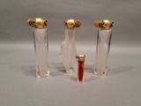 two clear glass vases with a gold top and a red top