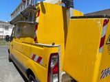 a yellow truck with a ladder on the back of it