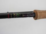 a close up of a fishing rod with a wooden handle