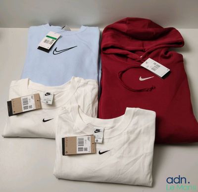 three shirts are sitting on a table with a price tag attached to them