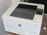 a printer sitting on top of a desk next to a monitor