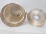 a silver bowl and a silver bowl on a white surface