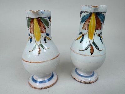 two vases that have been painted with flowers on them