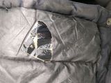 a piece of paper sticking out of the back pocket of a backpack