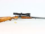 a rifle with a scope and a scope on a white background