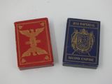 pair of two playing cards with gold and red covers