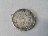 a silver coin with a crown on top of it