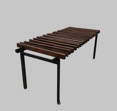 a wooden bench that is sitting on a gray surface