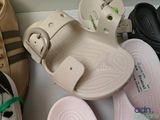 several pairs of sandals are lined up on a white surface