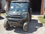 an image of a utility vehicle parked in front of a house