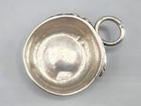 an antique silver plate with a ring on top of it