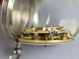 a close up of a pocket watch with a chain around it