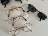 several pairs of glasses sitting on top of a table next to each other