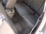 a person holding a cell phone in the back seat of a car