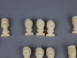 a lot of statues that are on display on a table