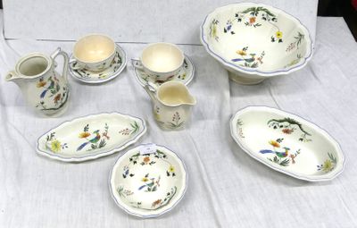 a table that has a bunch of dishes and cups on it